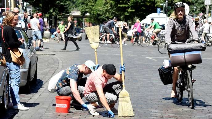 Residents clean the street during a 